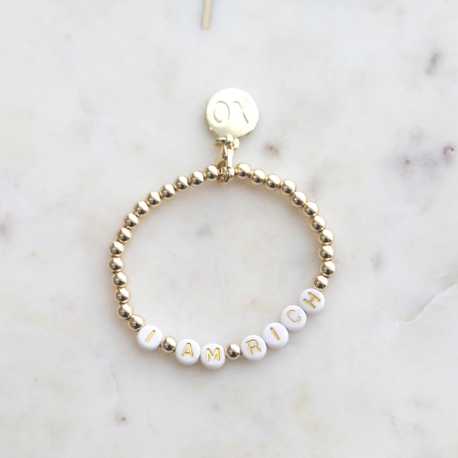 Close-up of 'I AM RICH' Affirmation Bracelet from AGERICH by Mrs V