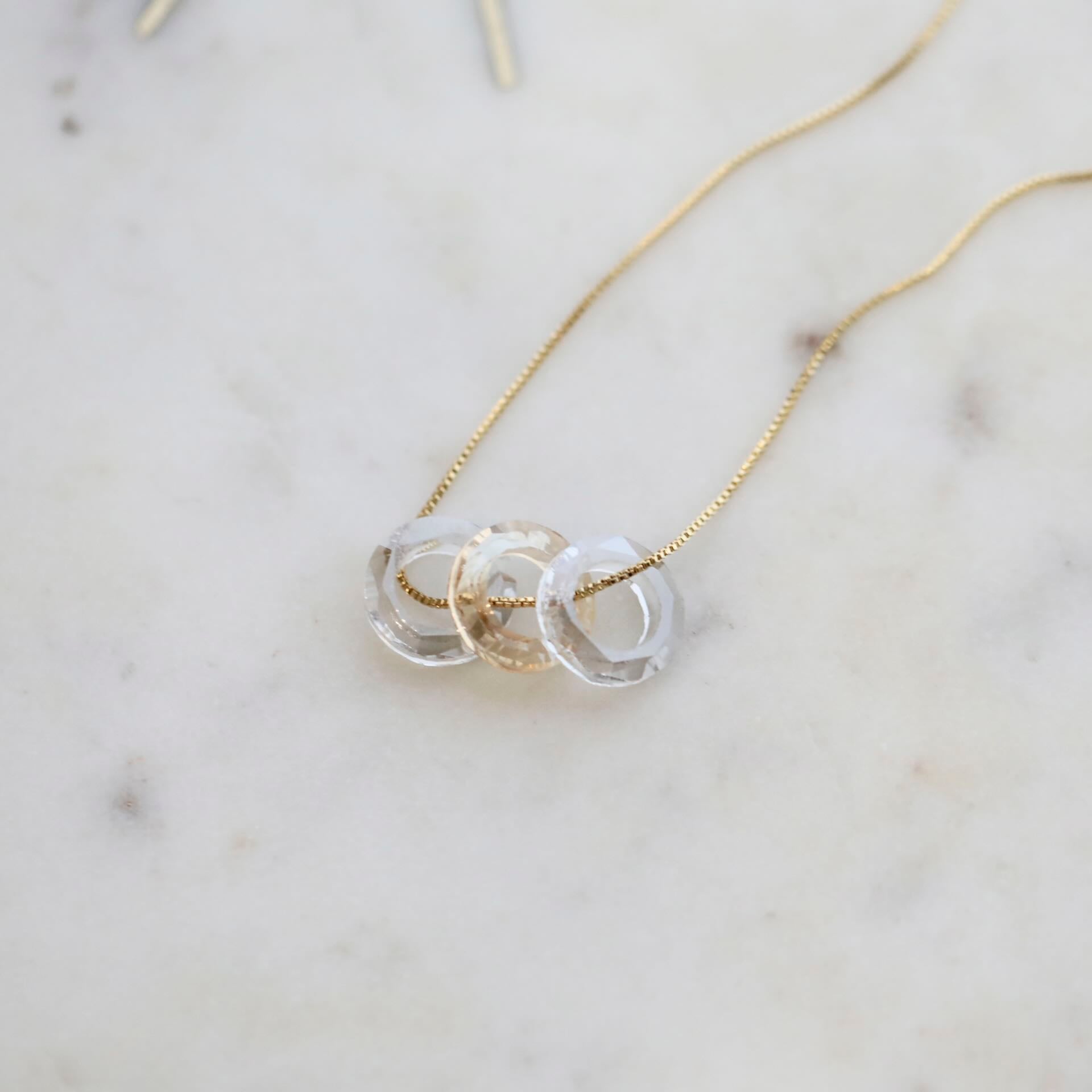 Close-up of Intertwined Rings with Crystals in Necklace by Mrs V