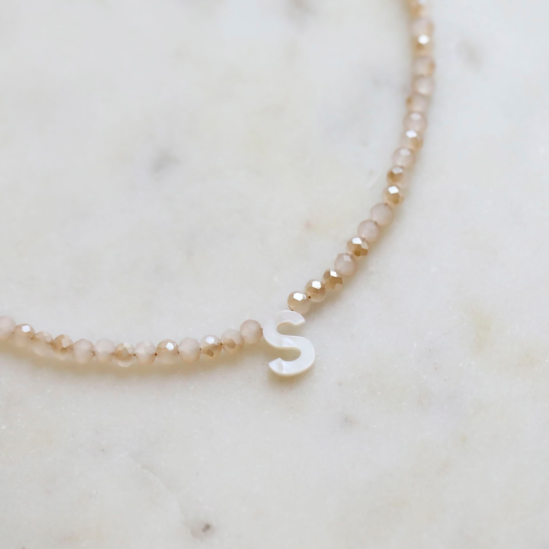 Close-up of Crystal Bead Necklace with Mother of Pearl Letter Pendant by Mrs V